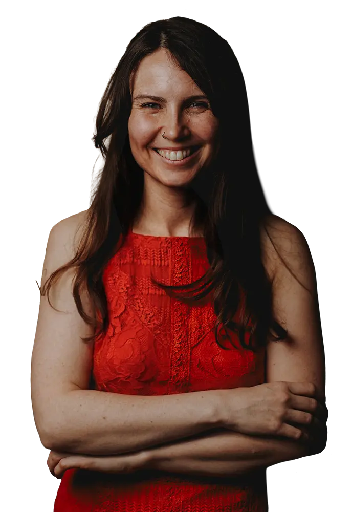 Photo of Cat Johnson smiling at the camera, wearing a red dress