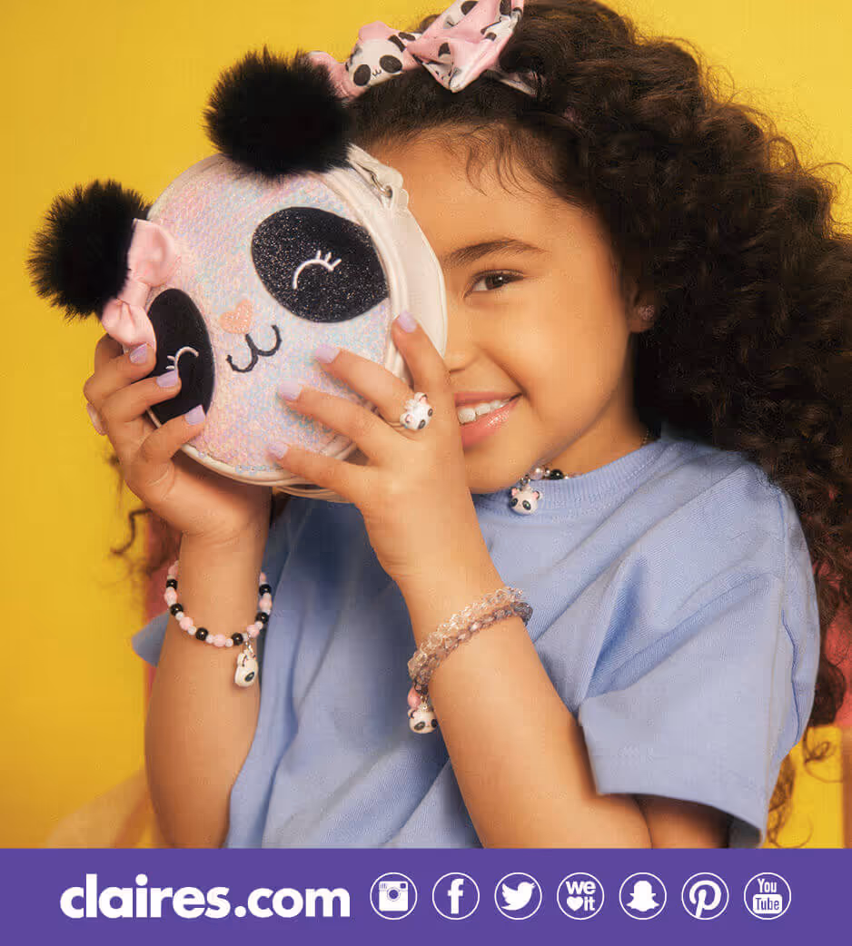Young girl holding up a panda pouch