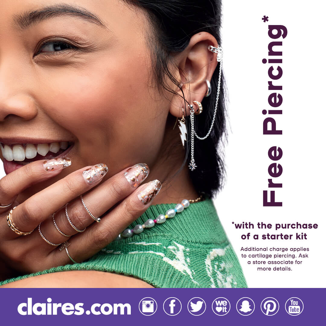 Young woman smiling with a closeup of her ear piercings