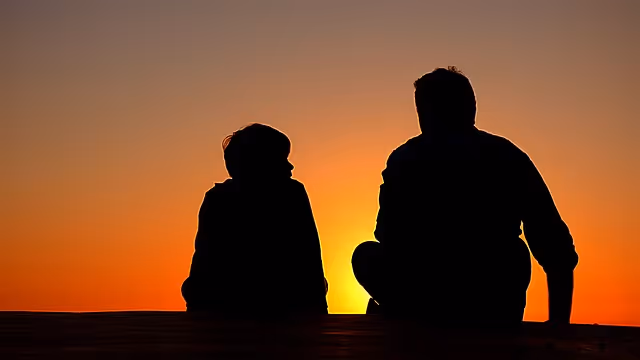 father and sun watching sunset
