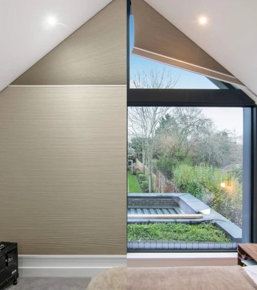 Blindspace pleated blind in gable angled window of vaulted bedroom