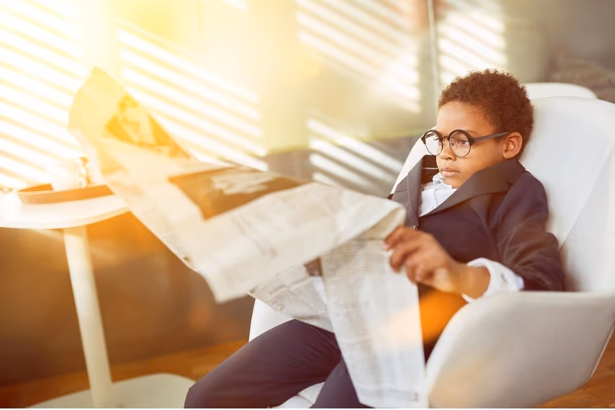 Child reading newspaper
