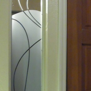 Photo of decorative partition on front door window of a home.