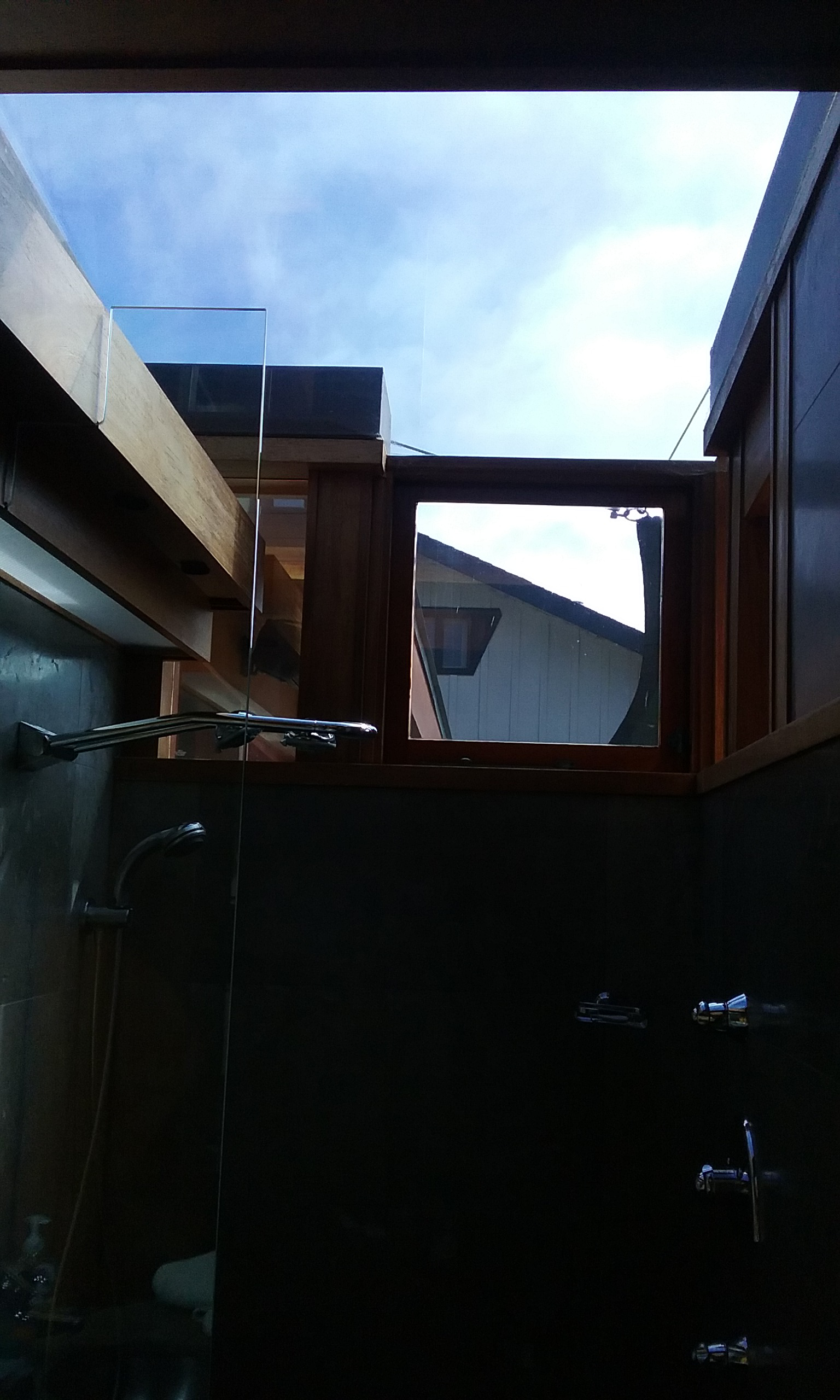 Photo of overhead glass in shower being tinted to reduce incoming heat.