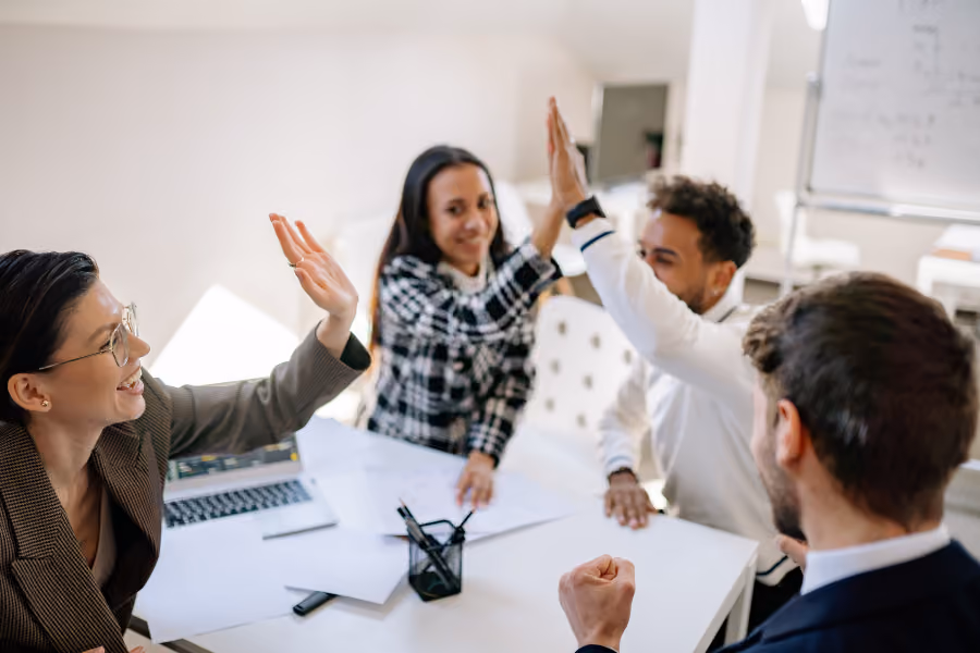 Resilient employees high fiving