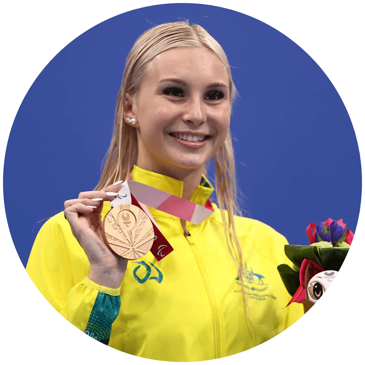 Girl holding medal she won at the paralympics