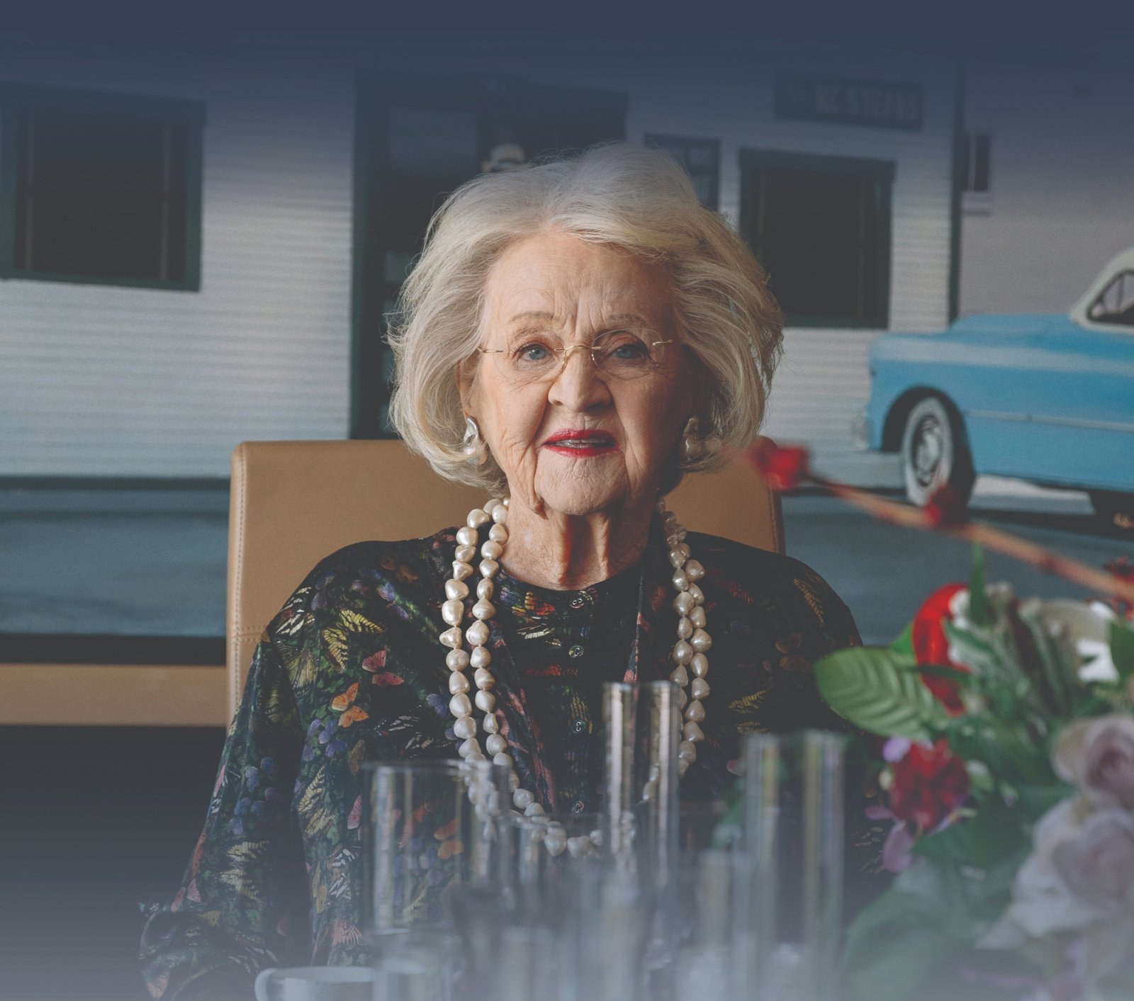 Rosemary Kowalski seated at a table inside The Rosemary Museum