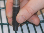 Photo of a PosiTector 6000 F0S measuring powder thickness on a metal part