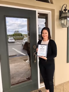 Cindy Howard, representing Bowen & Schroth holding a Thank You plaque