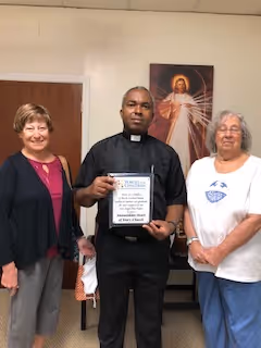 Lucille Blom, Father Stephen Ogonwa and Joann Post of Immaculate Heart of Mary in Ocala