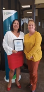 Jessica Ferraro and Elizabeth McWilliams of Cadence Bank accepting Voices for Children plaque