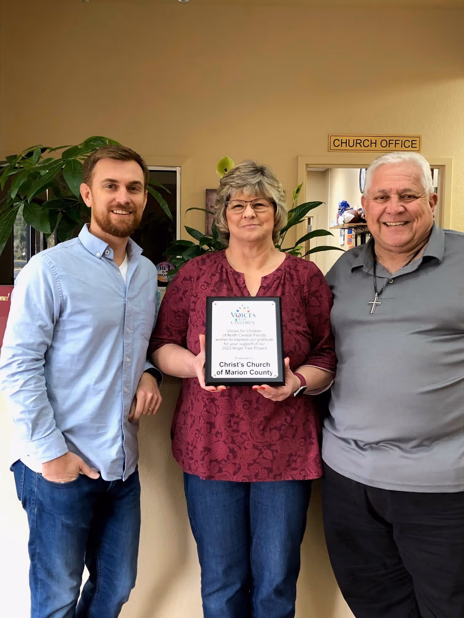 Representatives from Christ's Church of Marion County holding a recognition plaque
