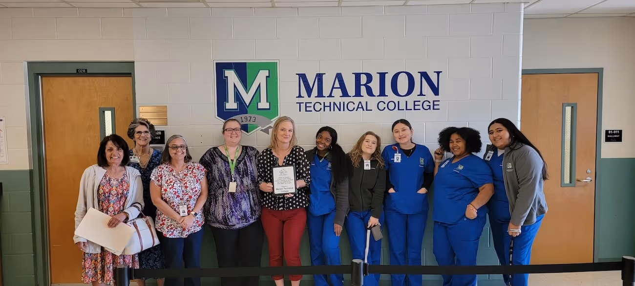 Photo of a few of the Marion Technical College staff and students who participate in our Tree of Angels project.