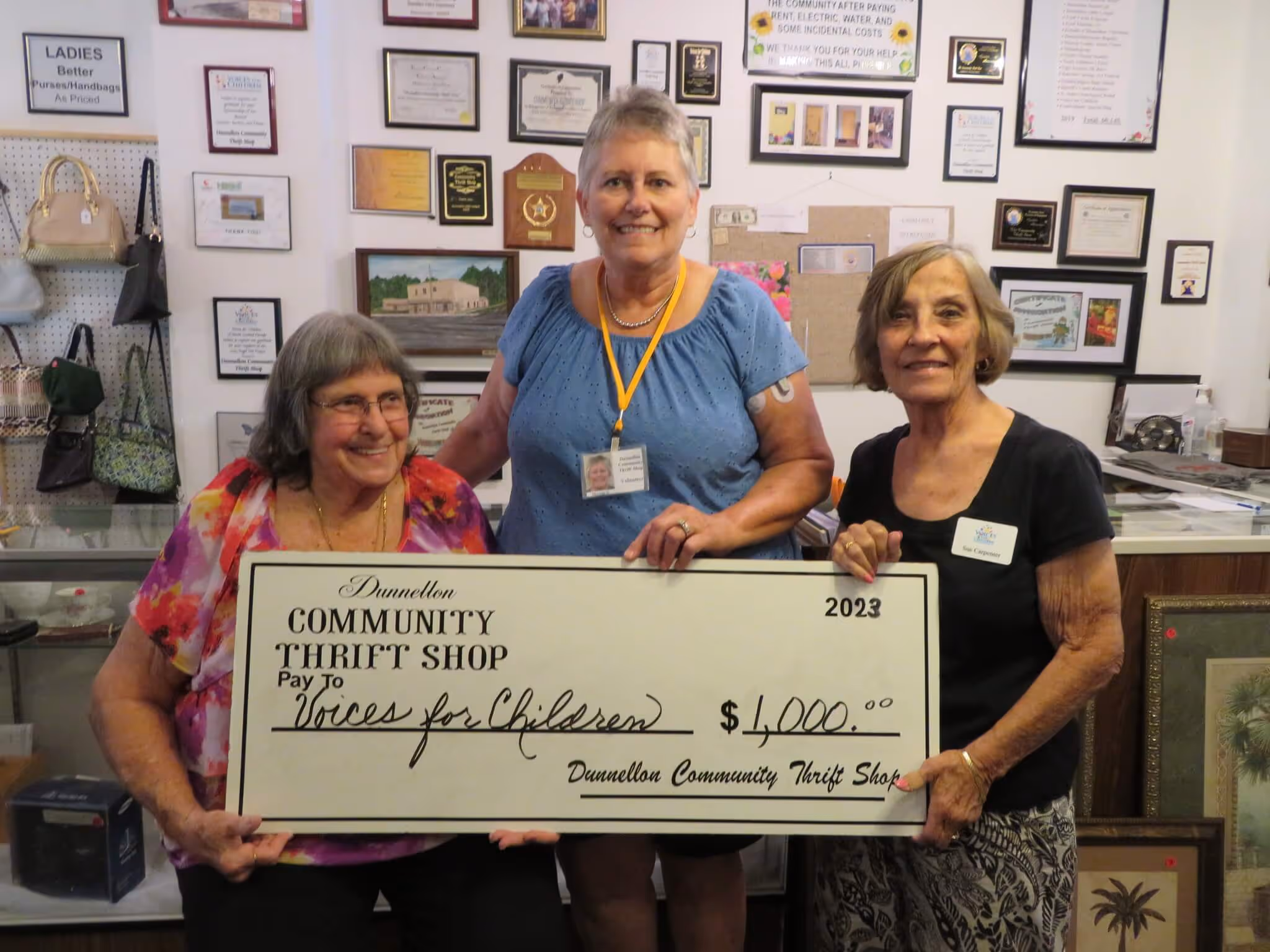 Bonnie Dean (l) and Marcia Smith of The Dunnellon Community Thrift Shop presenting a $1000 check to Sue Carpenter, Voices for Children.