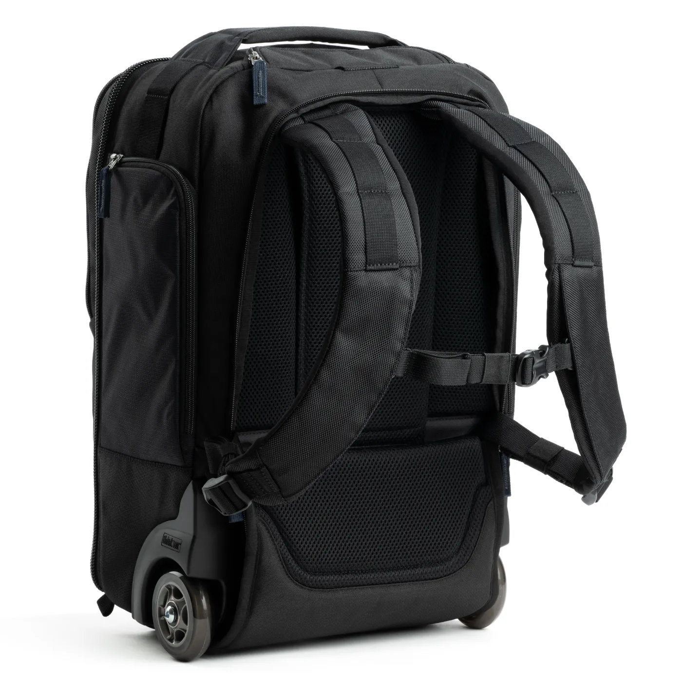 Zwarte Think Tank rolling backpack van achteren, met schouderbanden en wieltjes zichtbaar.