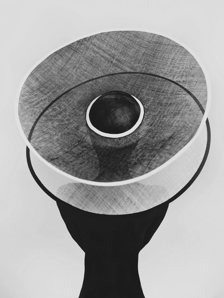 photo: © Rhythm - Bastiaan Woudt, top-down black-and-white portrait of a figure beneath a wide translucent circular hat