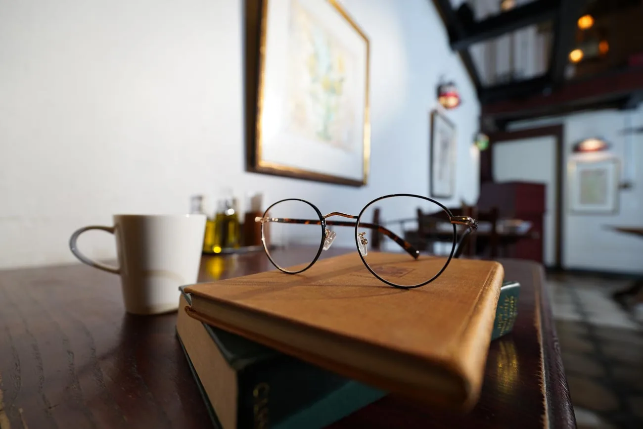Glasses on books in a cafe, photographed with the Sony FE PZ 16-35mm F4 G