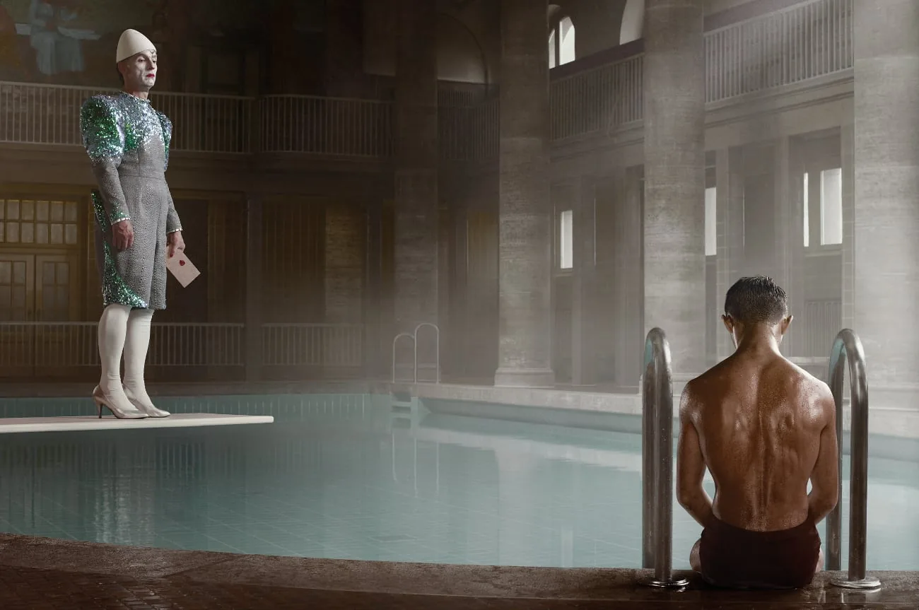Staged photo of a woman on a diving board and a man in a swimming pool by Erwin Olaf