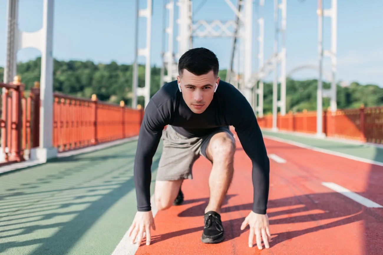 Athlete in starting position on a running track