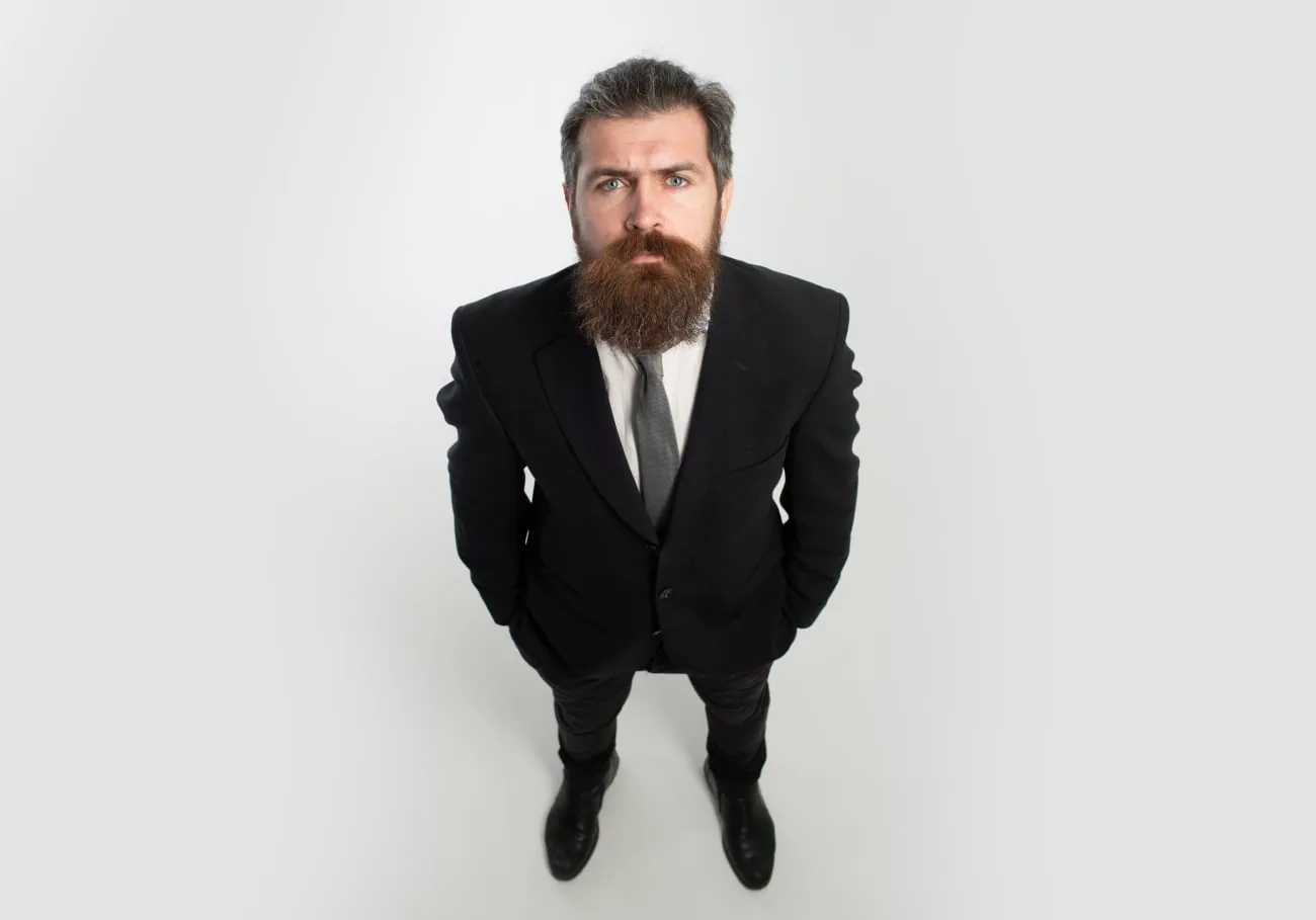 Bearded businessman in a black suit photographed from above