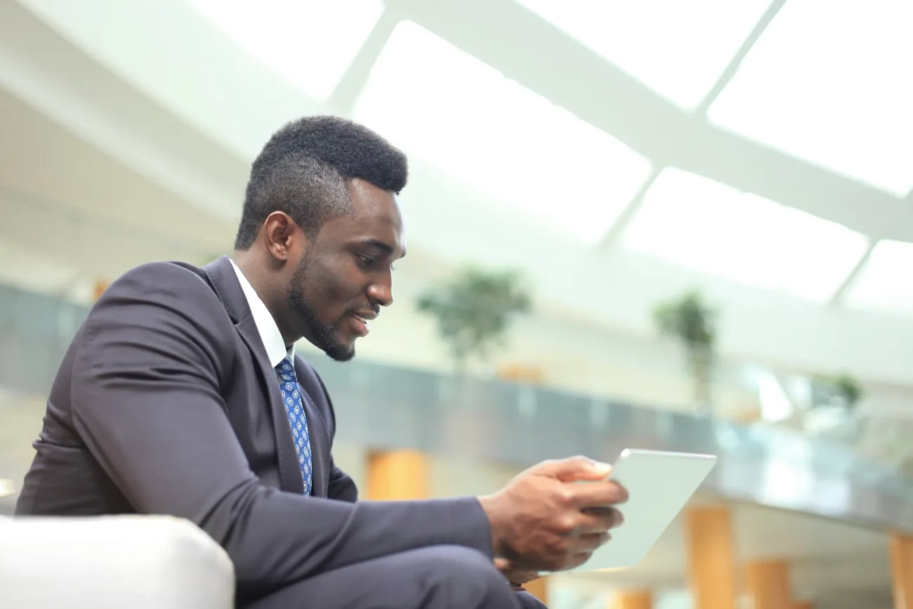 Businessman in suit looks at a tablet