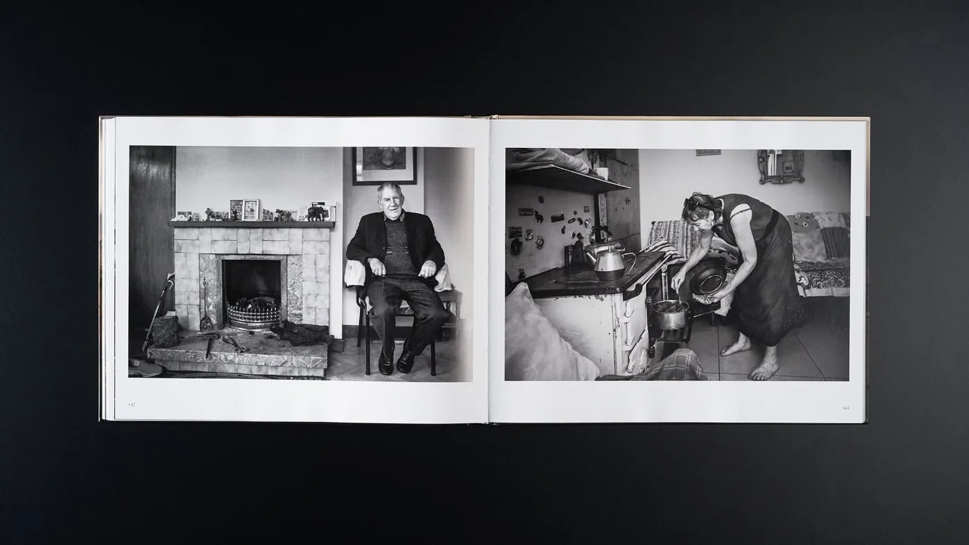 Open photo book Peat with black and white photos of people indoors