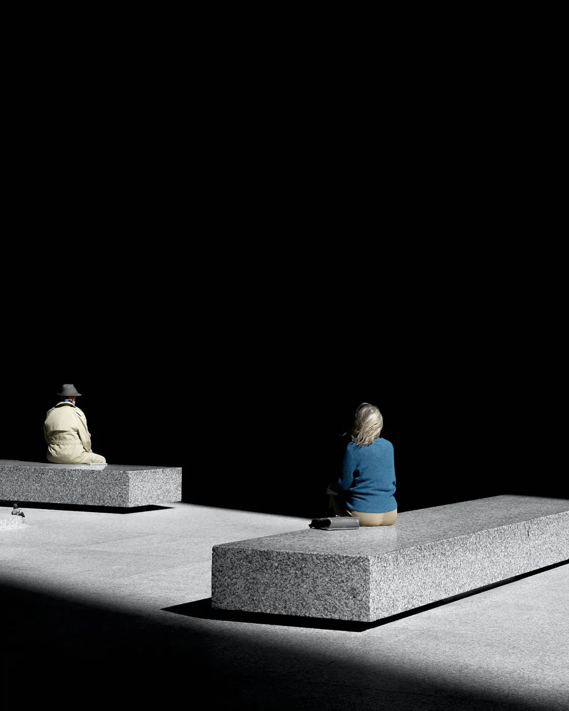 photo: © Clarissa Bonet, two people sitting outdoors on stone benches
