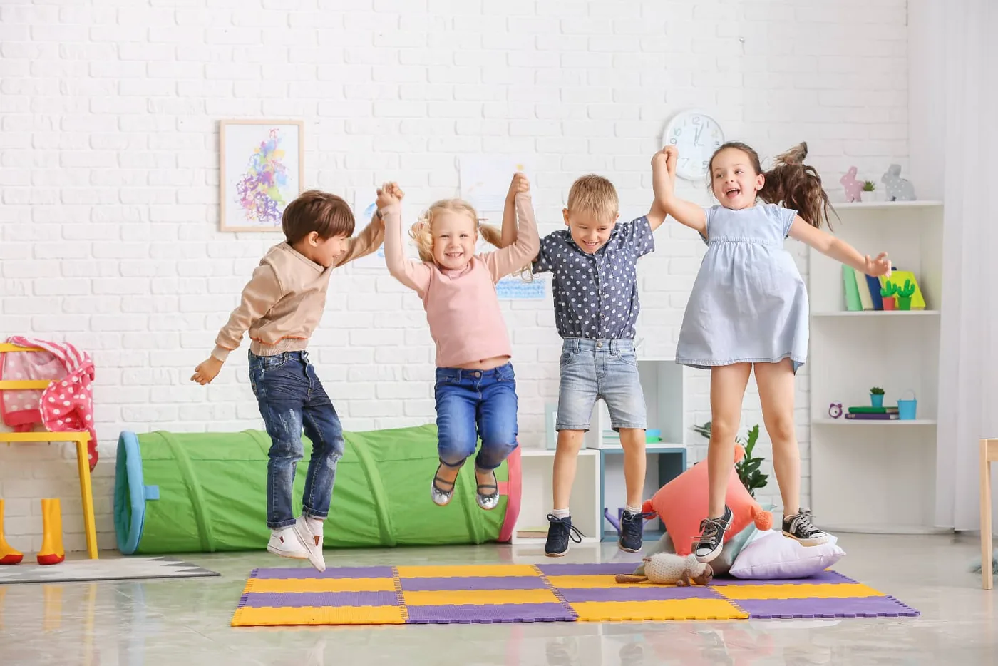 children at a daycare jumping hand in hand