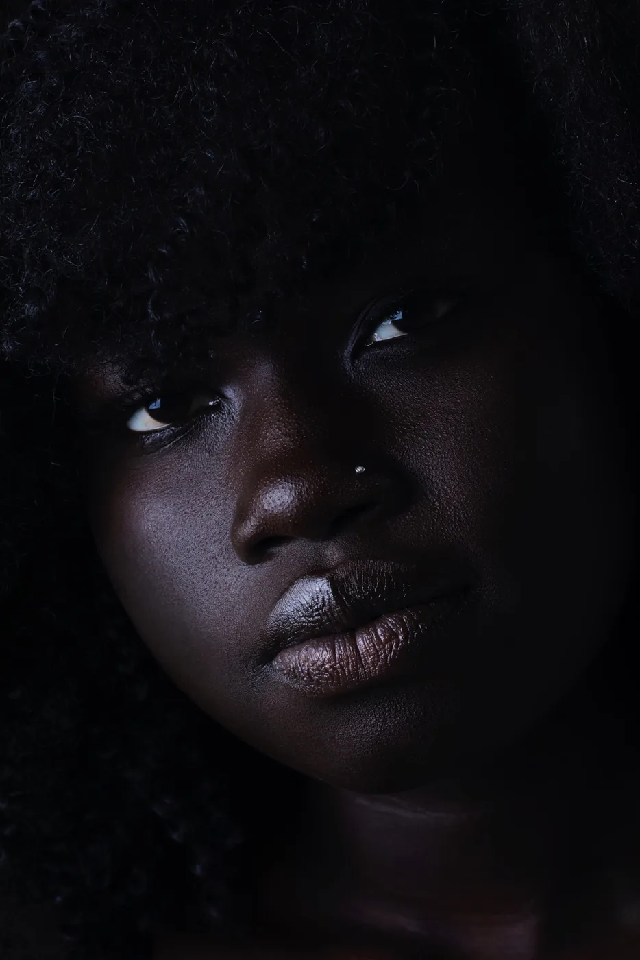 Photo by Zelle Westfall: close-up portrait of a dark-skinned woman