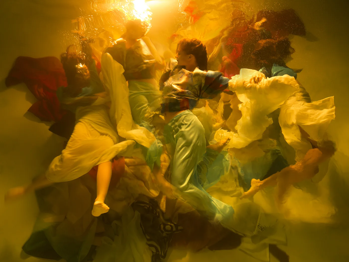 Photo by Christy Lee Rogers: women underwater with flowing fabric