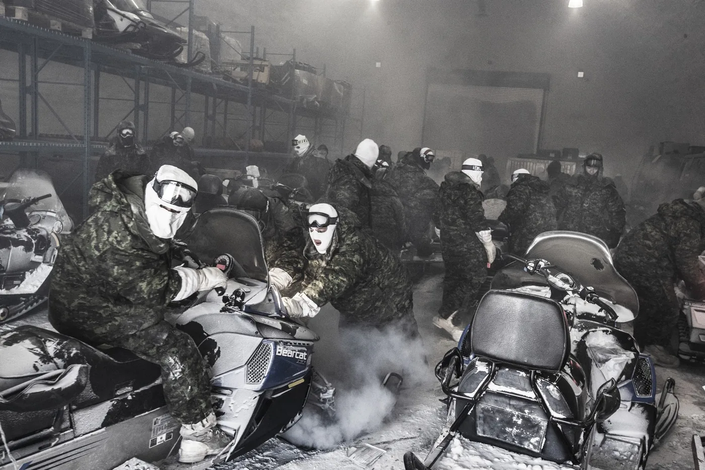 Men in military clothing and helmets aboard icebreakers in the Arctic