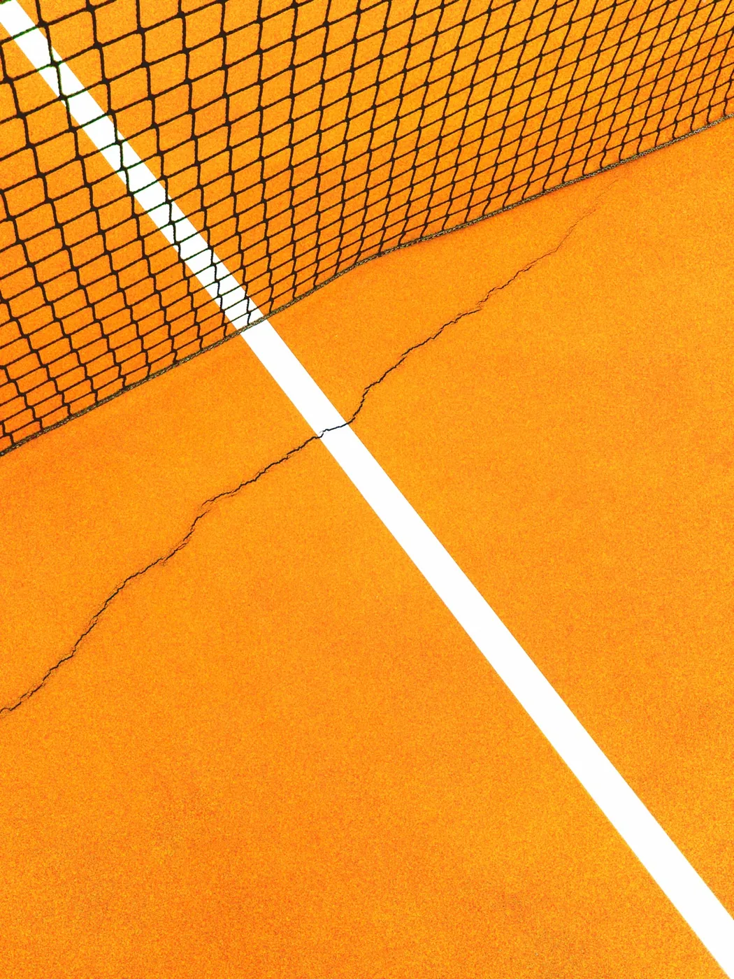 Tennis-court net above a court with a visible crack