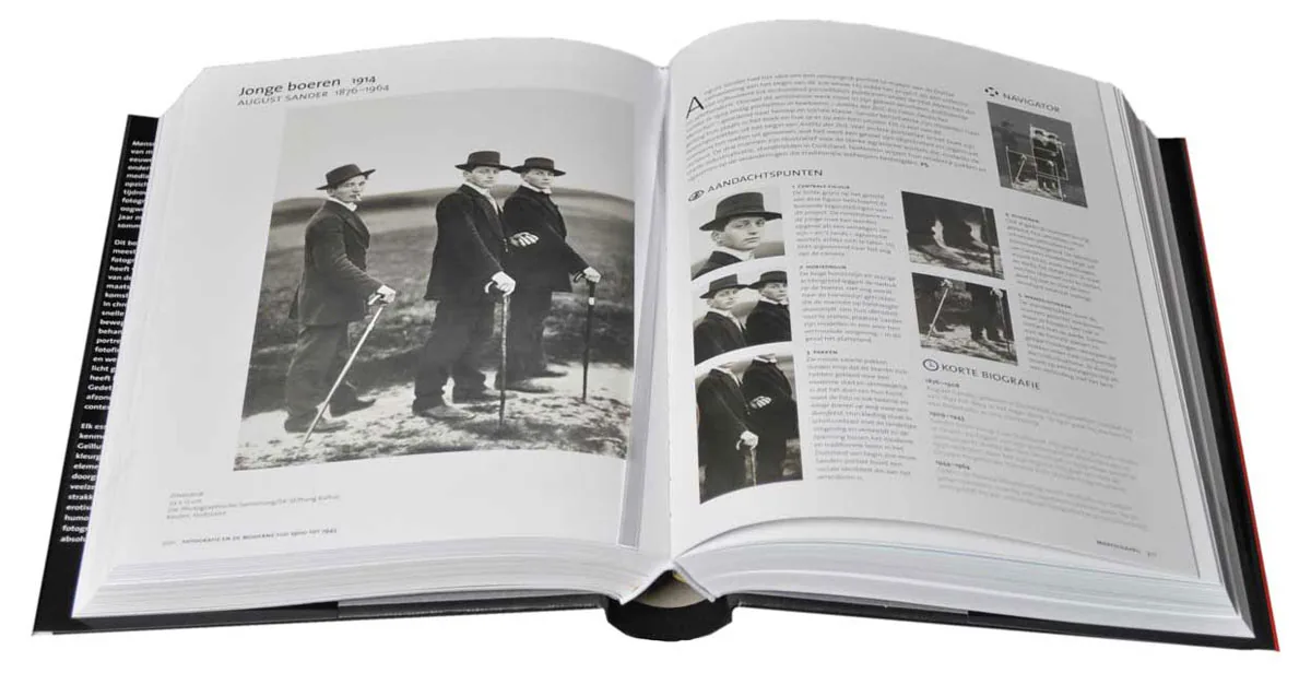 Open book about photography history with black and white photos