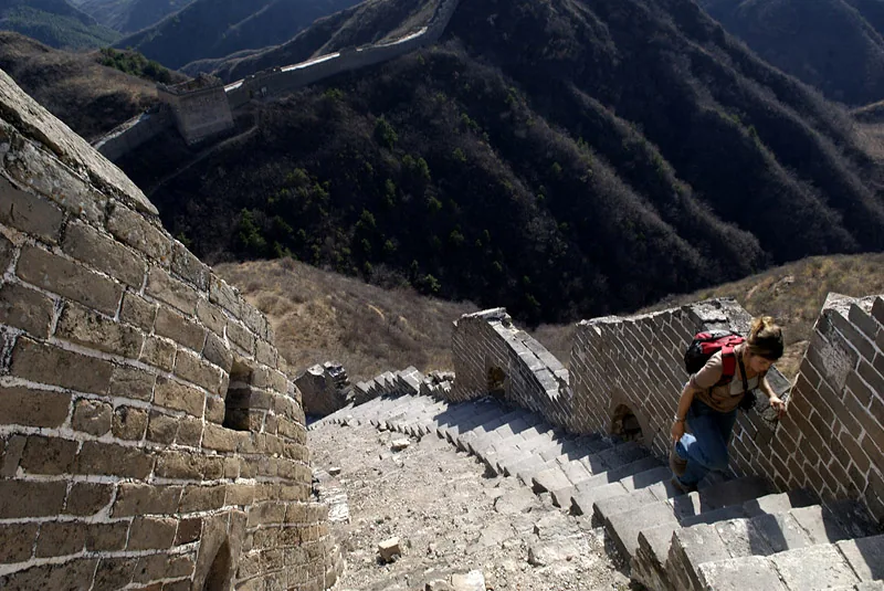 Visitor climbs a steep section of the Great Wall of China