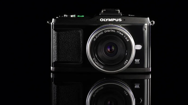 Olympus PEN E-P2 with 17mm lens on a black mirror surface