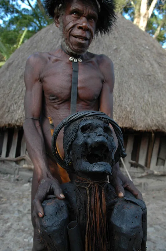 photo: Tom van der Leij - man with a mummy in Irian Jaya