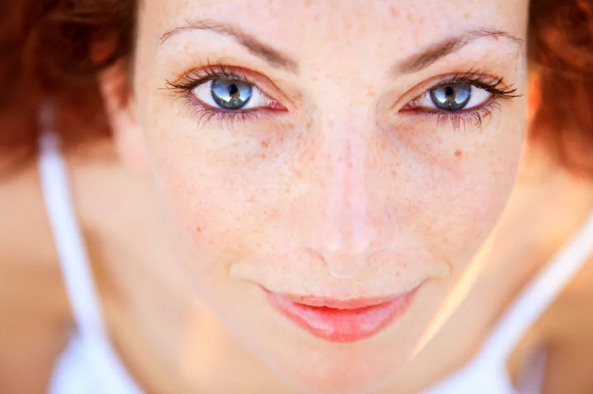Close-up of the face and eyes of a red-haired woman