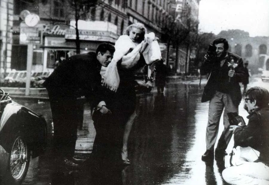 Paparazzo photographing celebrities in black and white