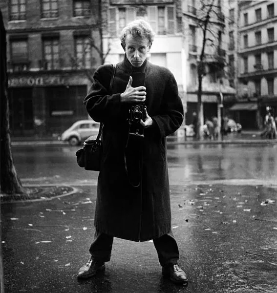 Self-portrait of Ed van der Elsken with a camera on a Paris street