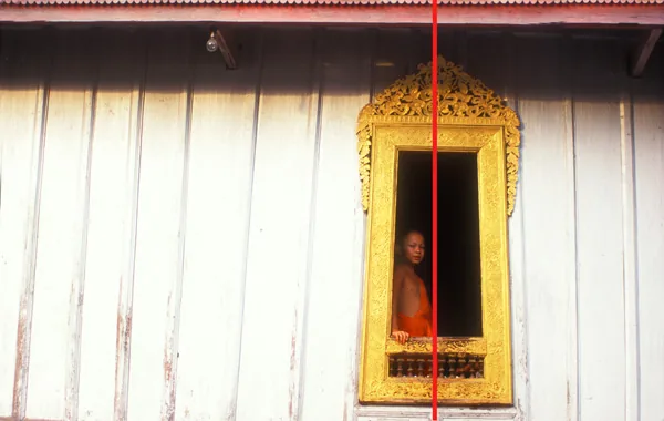 Young monk in a window (Laos)