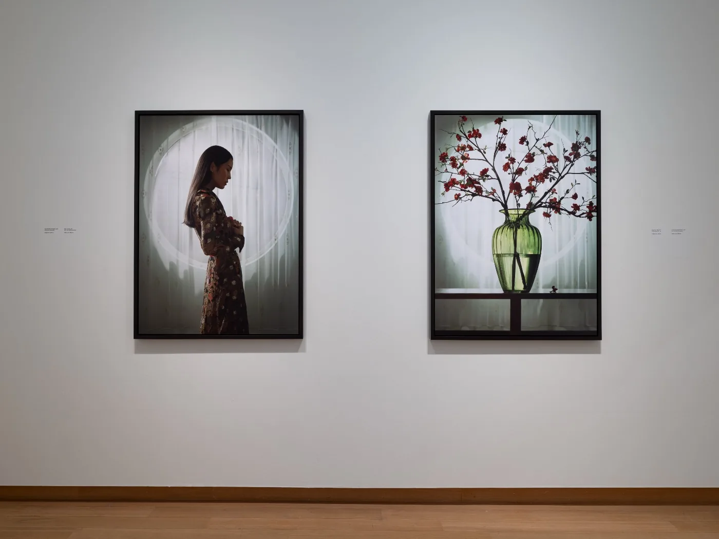 Two framed photographs from Erwin Olaf’s Freedom series at Stedelijk Museum Amsterdam, photographed by Peter Tijhuis: a woman in profile before a circular window and a green vase with flowering branches before a window
