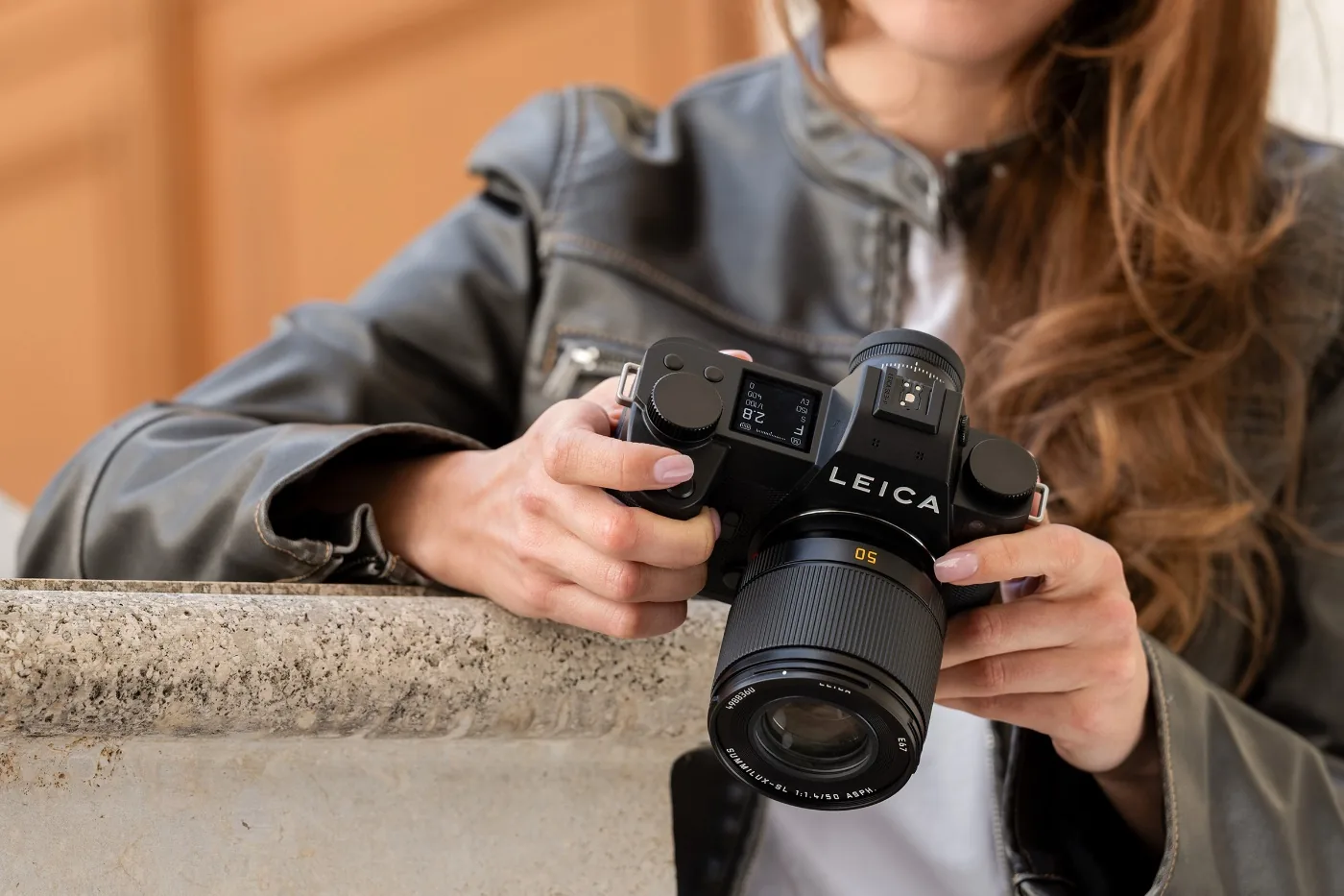 Leica SL3-P held by a woman with a Summilux-SL 50mm f/1.4 lens