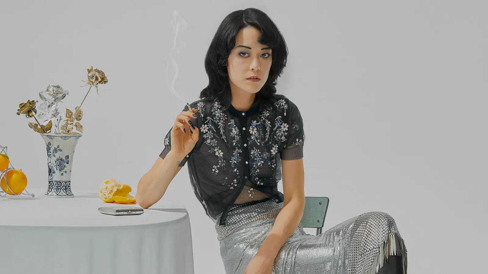 Heroine-Nhu Xuan Hua, fashionable woman with cigarette at the table