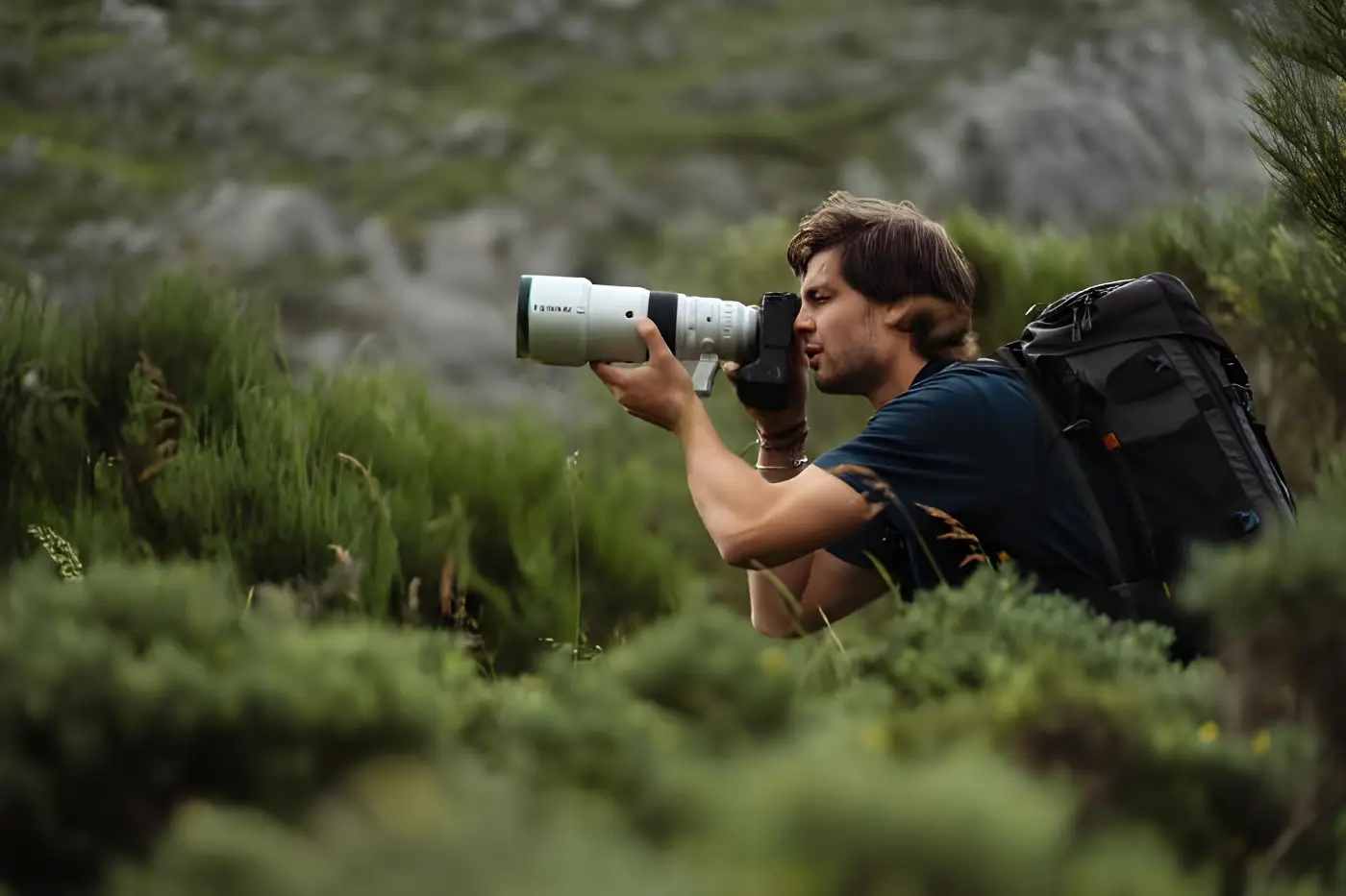 Nature photographer works handheld with the Fujifilm XF 400mm f/4.5 in mountainous terrain.