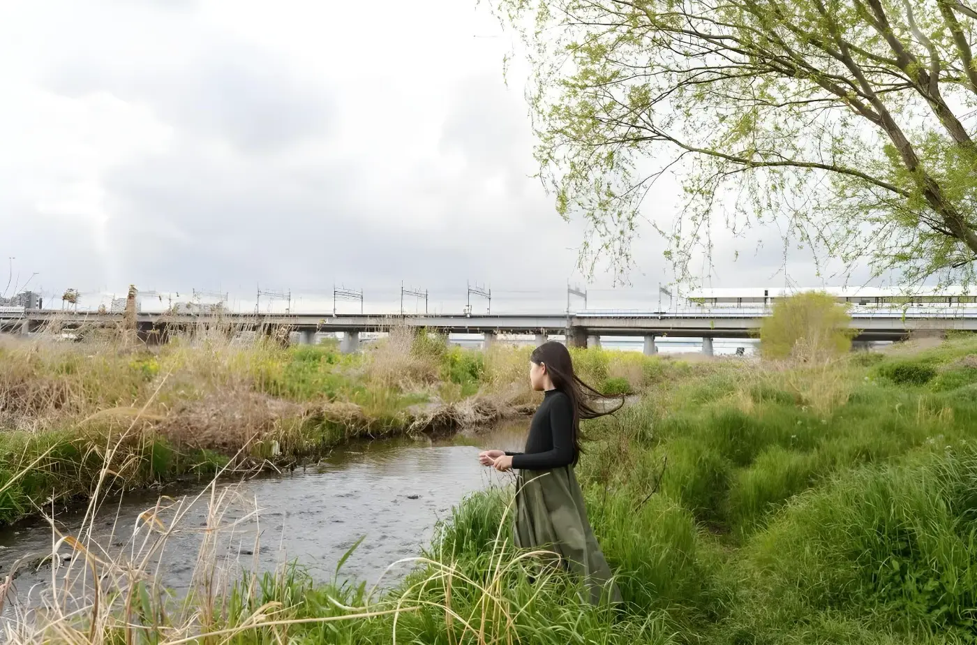 Girl standing beside a ditch, photographed with the Sigma 20-60mm F2.8-4 DG Contemporary.
