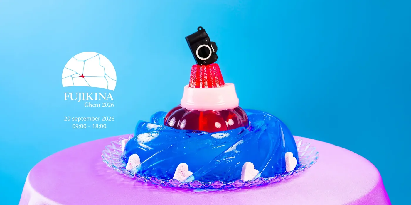 Official FUJIKINA Ghent 2026 campaign visual: a camera on colourful layers of jelly against a blue background.