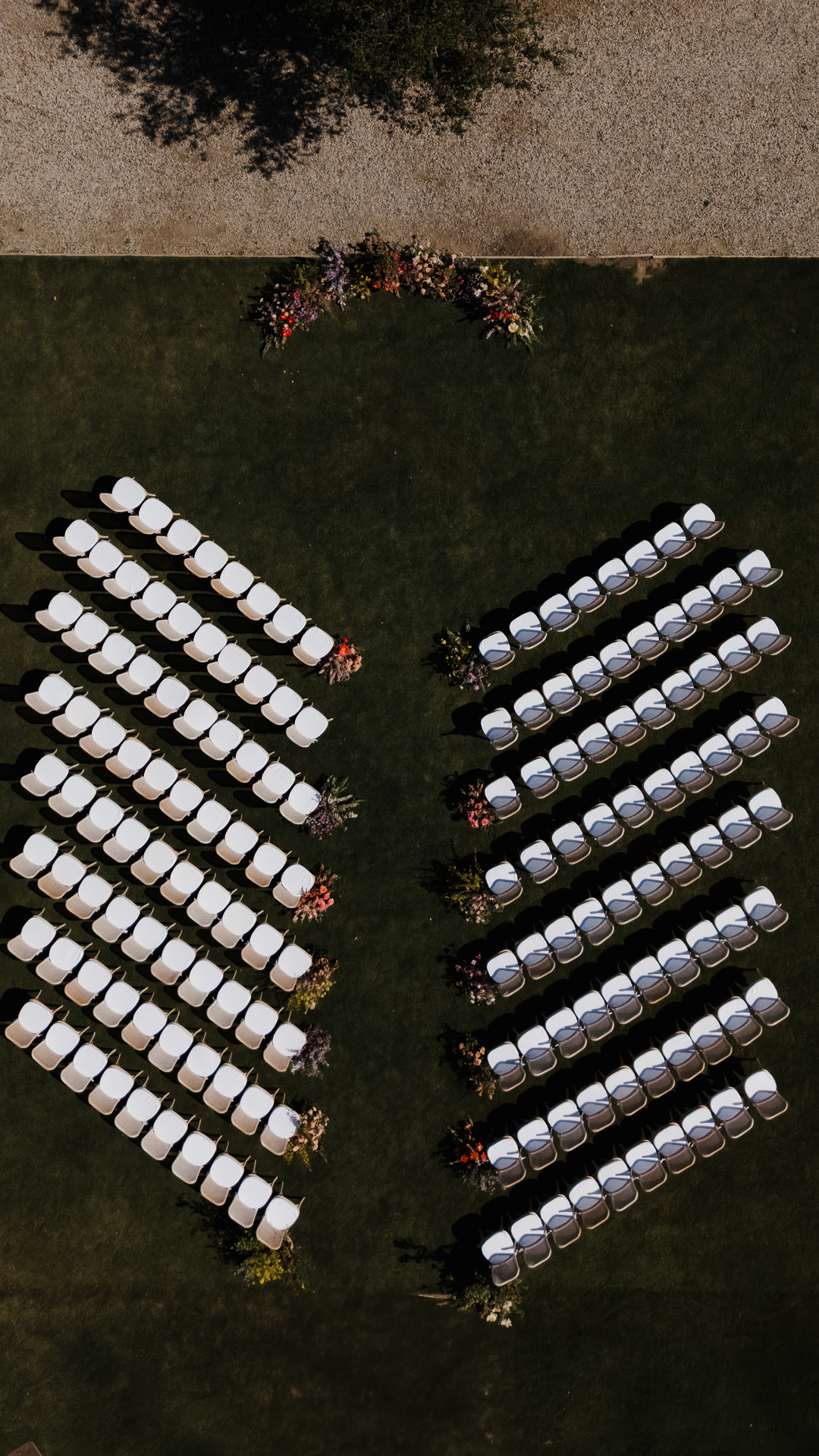 Outdoor wedding ceremony with colorful floral decor.