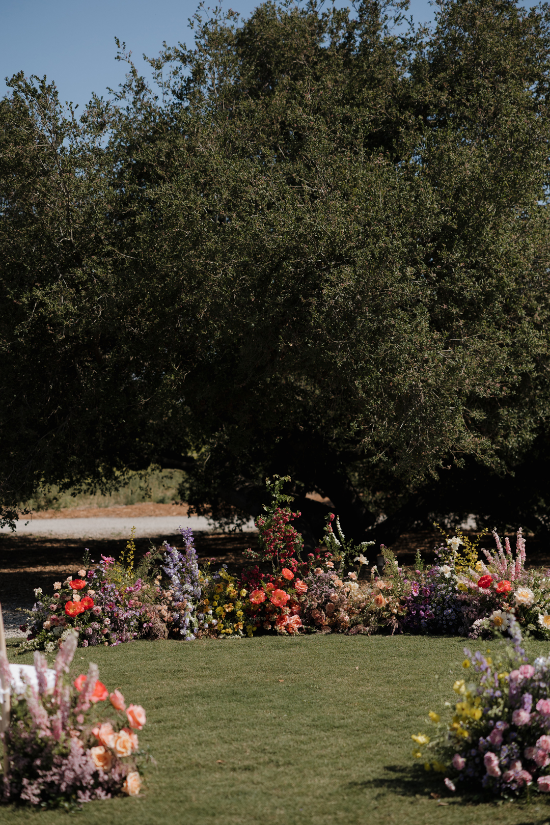 Colorful floral floor install for outdoor wedding in Southern California.