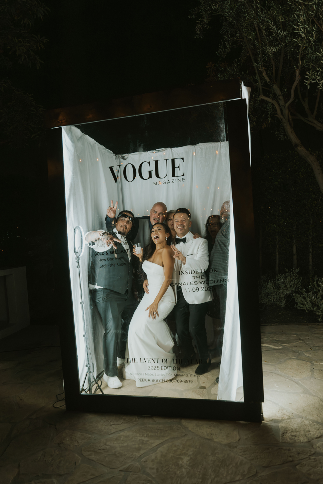 Bride, groom, and friends pose for photos in the photo booth.
