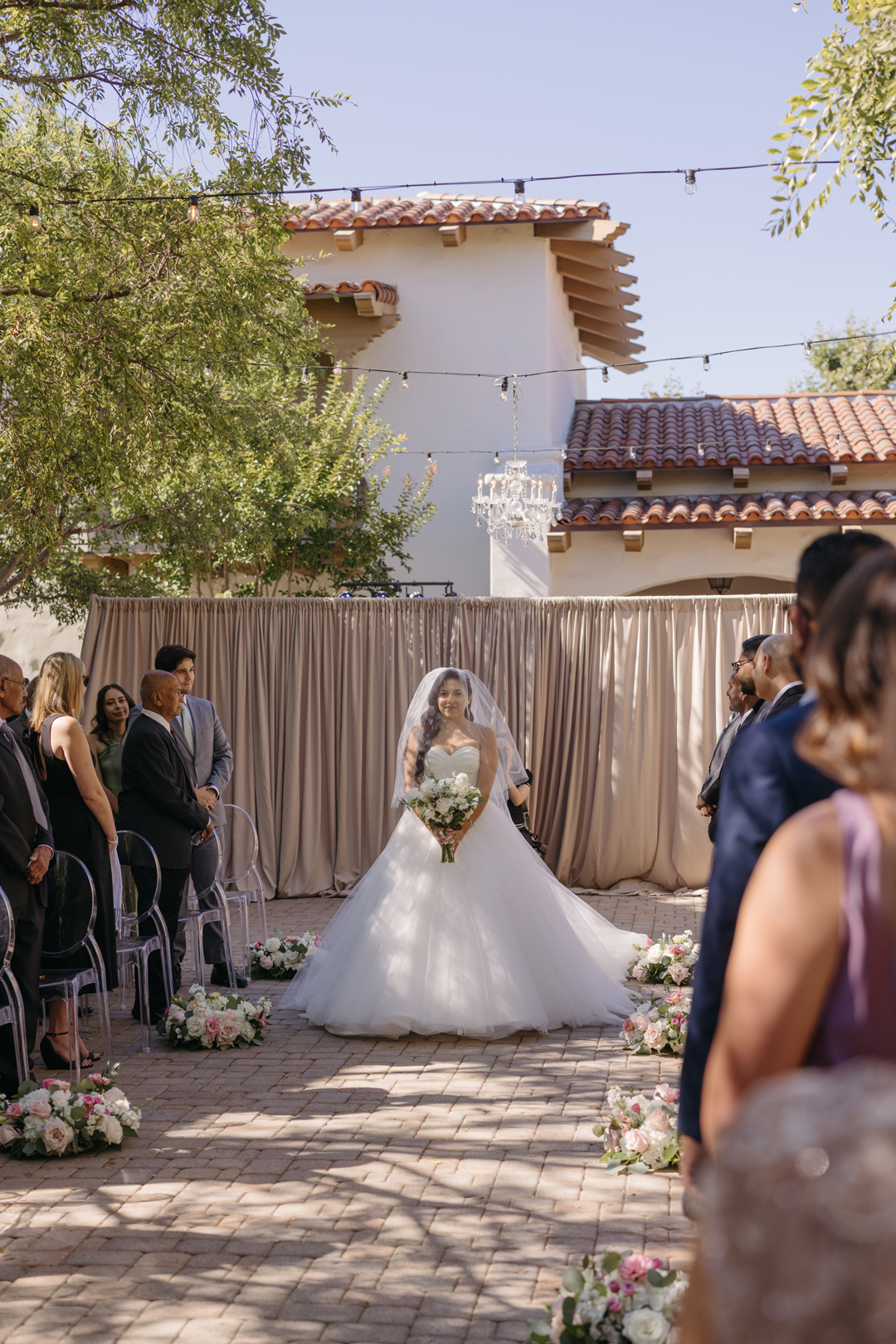 Bride makes grand entrance into wedding ceremony.